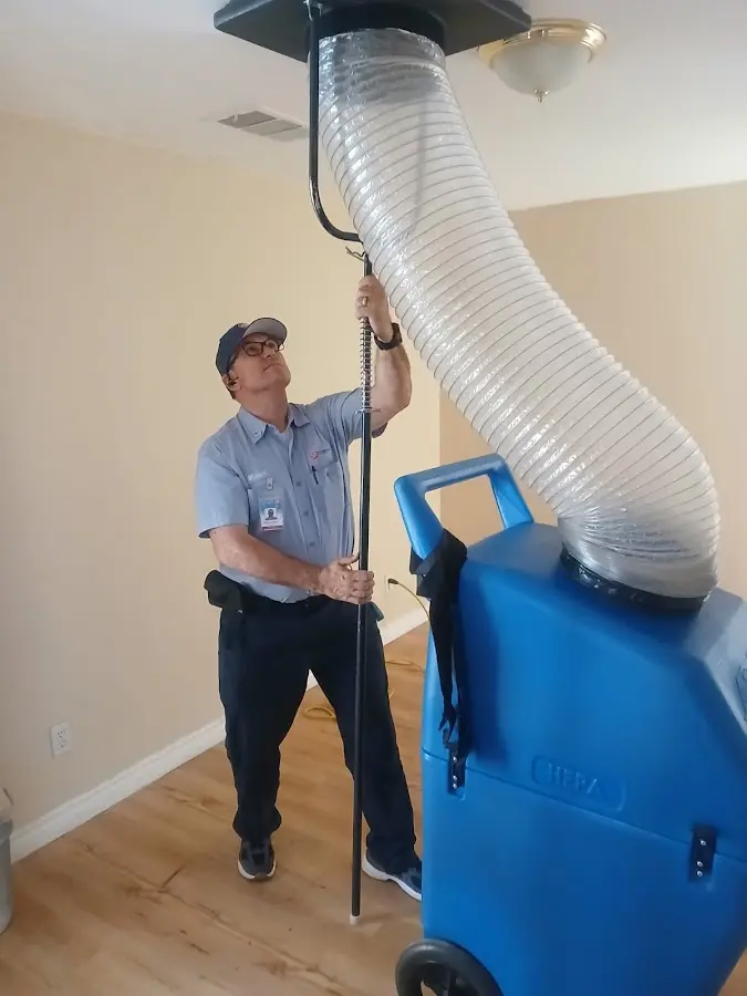 Furnace Tune-Up technician using HEPA equipment in Nacogdoches