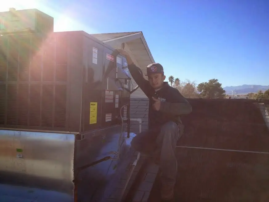 HVAC technician performing HVAC Inspection on a rooftop unit in Nacogdoches